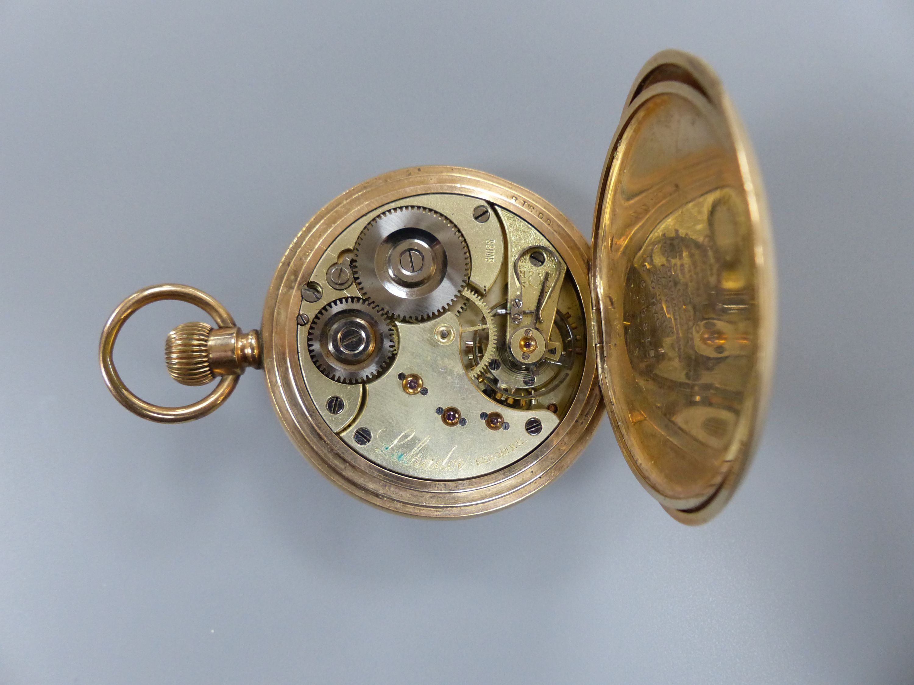 A gold plated half hunter pocket watch and a 375 and cultured pearl set tie pin, 55mm.